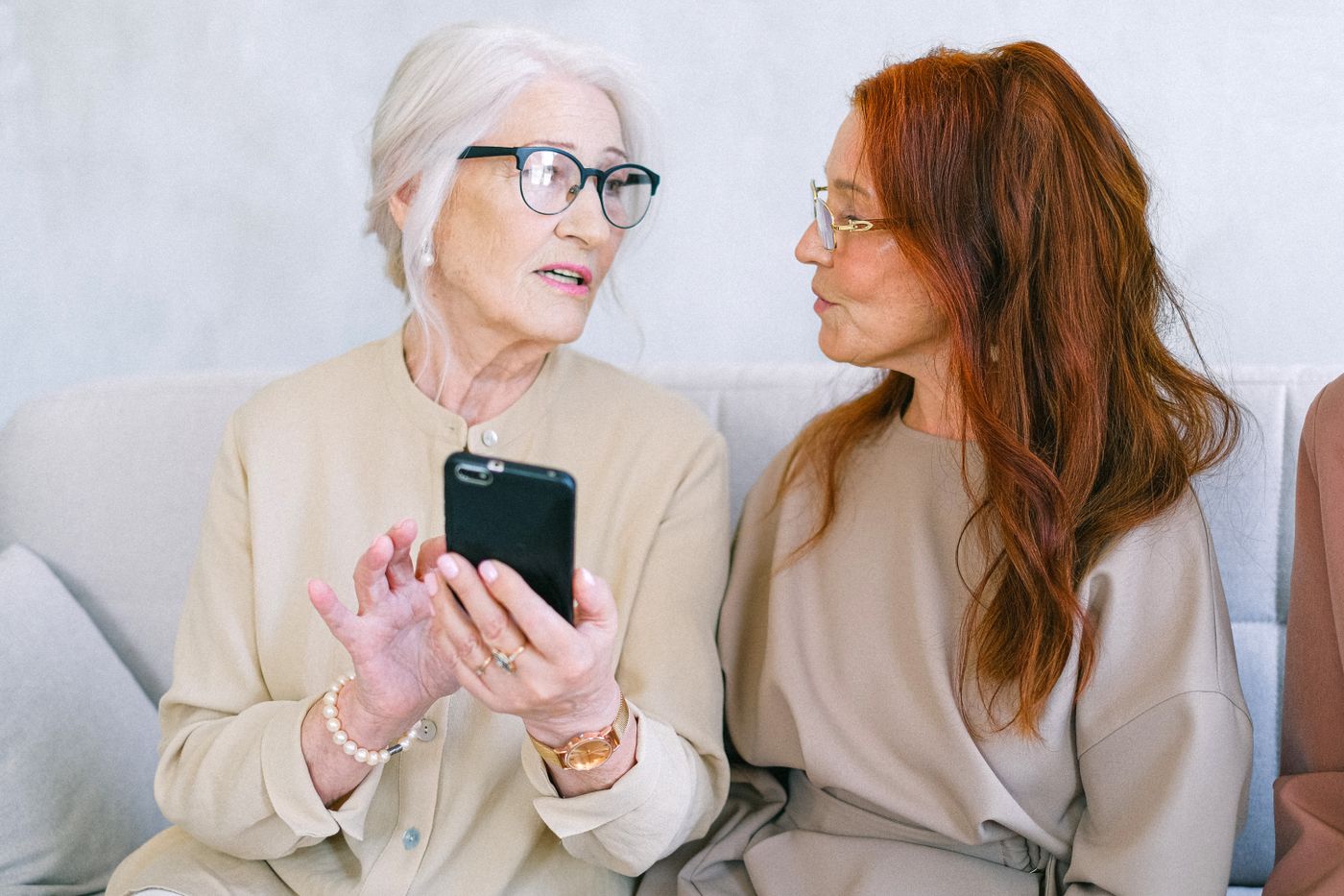 An adult offering informal help with a digital device